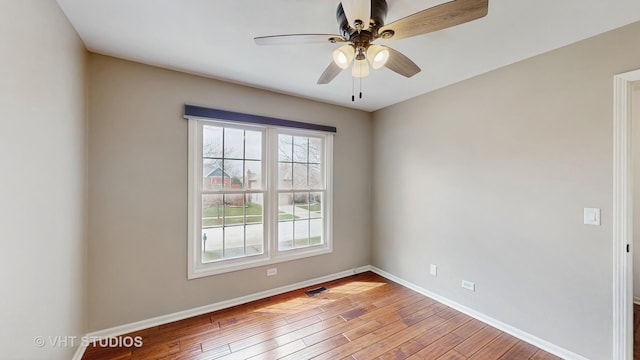 empty room with visible vents, light wood-style flooring, ceiling fan, and baseboards