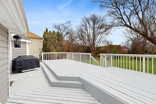 deck featuring grilling area and a lawn