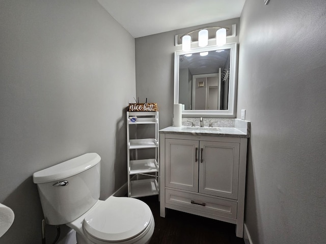 half bath featuring toilet and vanity