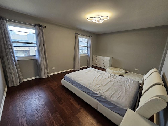 bedroom featuring baseboards and wood finished floors