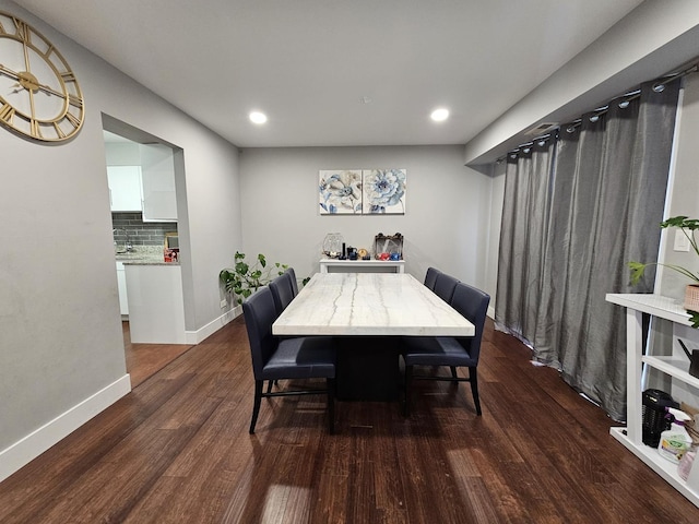 dining room featuring recessed lighting, baseboards, and dark wood finished floors