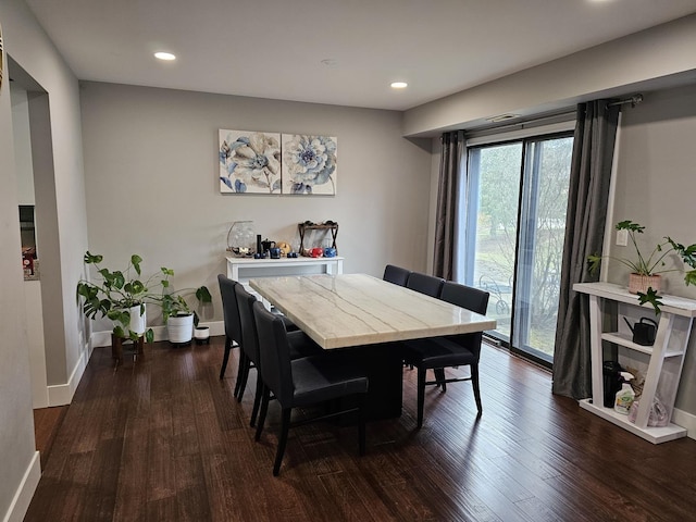 dining room with baseboards, dark wood finished floors, and recessed lighting
