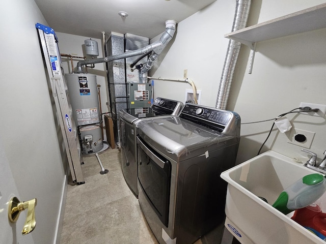 laundry area featuring independent washer and dryer, laundry area, a sink, and water heater