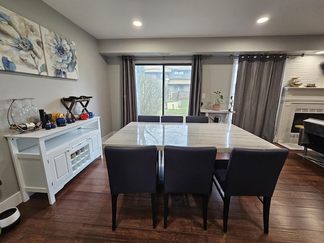 dining area with baseboards, dark wood finished floors, and recessed lighting