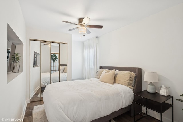 bedroom featuring a closet, baseboards, a ceiling fan, and wood finished floors