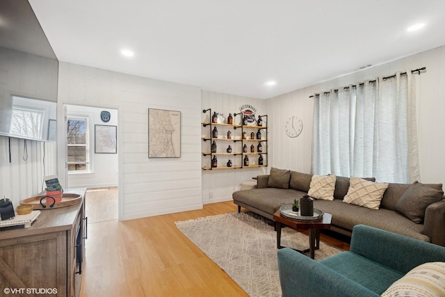 living room featuring light wood-type flooring and recessed lighting