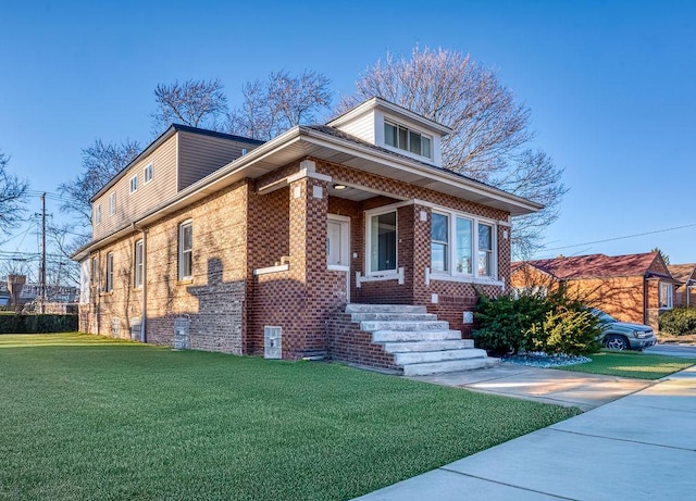 view of front of home with a front yard and brick siding