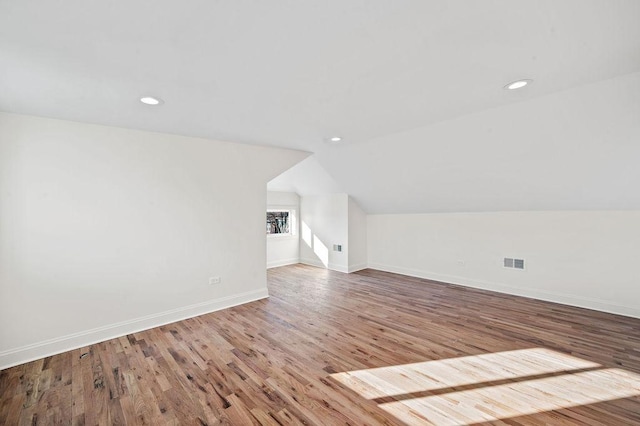 bonus room with vaulted ceiling, visible vents, recessed lighting, wood finished floors, and baseboards