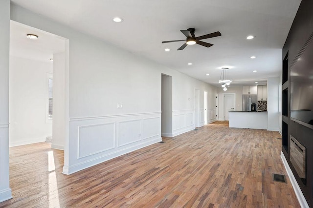 unfurnished living room with light wood-style floors, recessed lighting, visible vents, and a ceiling fan