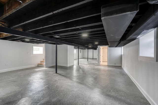 below grade area with stairs and baseboards
