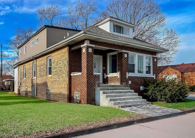 bungalow-style home with a front yard and brick siding