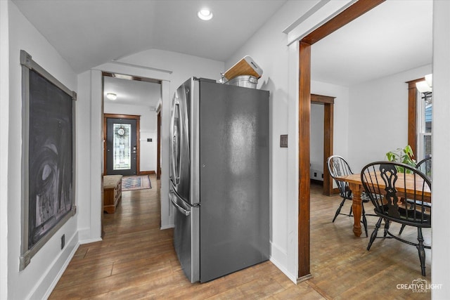 627 S Main St, Montgomery, IL 60538 - kitchen with freestanding refrigerator, wood finished floors, and vaulted ceiling