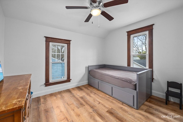627 S Main St, Montgomery, IL 60538 - bedroom with light wood finished floors, vaulted ceiling, and baseboards