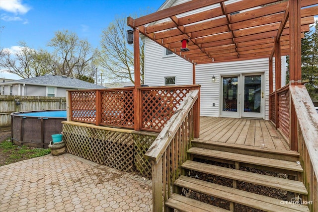627 S Main St, Montgomery, IL 60538 - wooden deck with fence, a pergola, an outdoor pool, french doors, and a patio