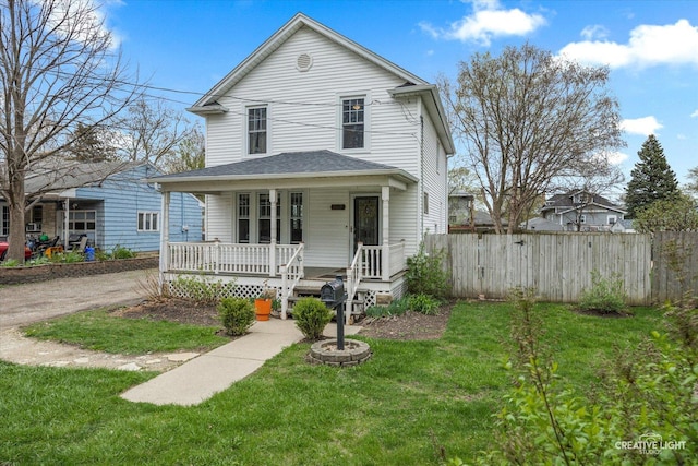 627 S Main St, Montgomery, IL 60538 - view of front of property featuring fence, a front yard, and covered porch