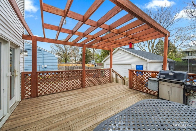 627 S Main St, Montgomery, IL 60538 - deck featuring an outdoor structure, a detached garage, a pergola, and fence