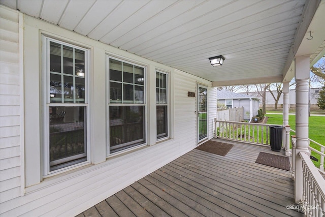 627 S Main St, Montgomery, IL 60538 - wooden deck featuring a porch and central AC unit