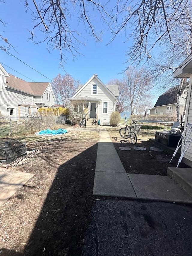 238 Ann St, West Chicago, IL 60185 - rear view of property featuring a trampoline and fence