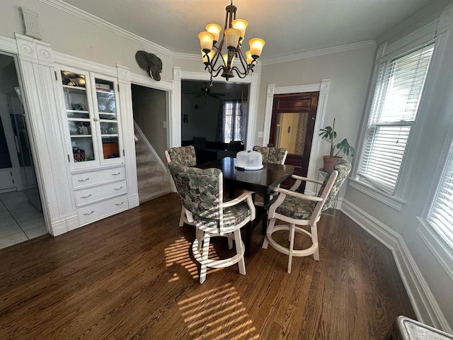 238 Ann St, West Chicago, IL 60185 - dining room featuring a chandelier, dark wood finished floors, crown molding, and a healthy amount of sunlight