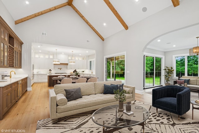 10940 German Church Rd, La Grange, IL 60525 - living area featuring high vaulted ceiling, light wood-style floors, beam ceiling, arched walkways, and recessed lighting