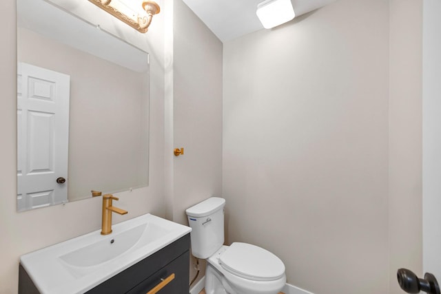 half bathroom featuring toilet and vanity