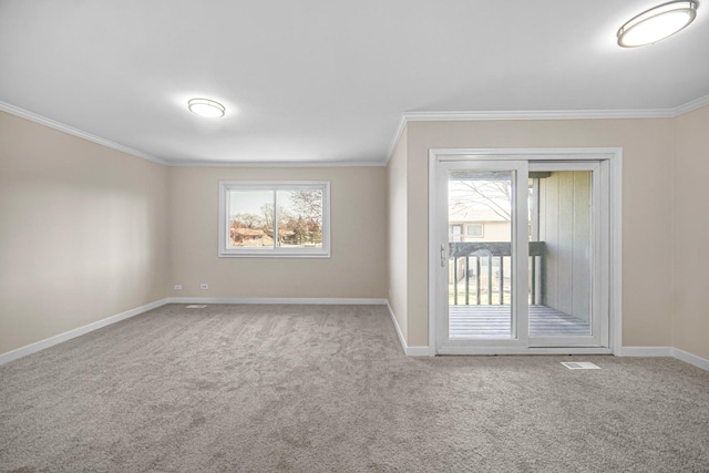 carpeted empty room with ornamental molding and baseboards