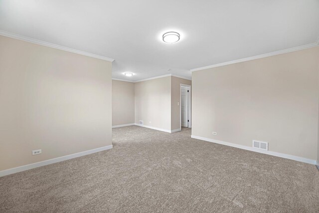 carpeted spare room with visible vents, baseboards, and ornamental molding