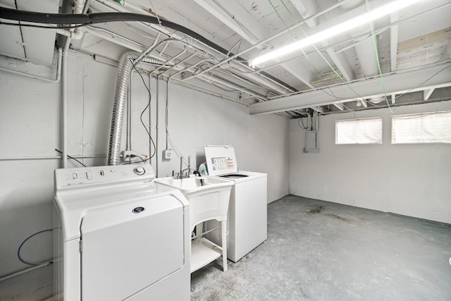 clothes washing area with laundry area, electric panel, and washing machine and dryer