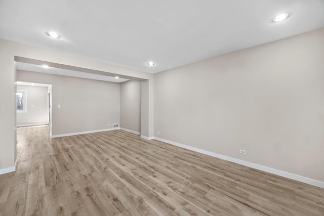 interior space with light wood finished floors, baseboards, and recessed lighting