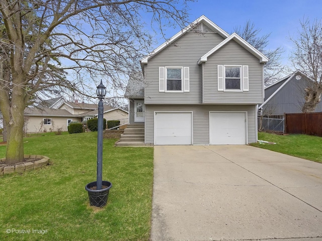 133 Abbeywood Cir, Streamwood, IL 60107 - view of front facade with an attached garage, concrete driveway, fence, and a front lawn
