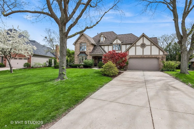 english style home with an attached garage, a front lawn, stone siding, stucco siding, and driveway