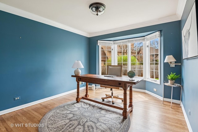 office featuring baseboards, ornamental molding, and light wood-type flooring
