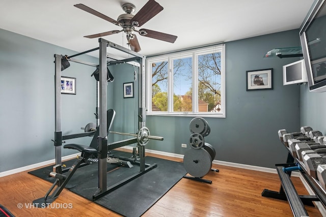 workout room featuring baseboards, ceiling fan, and wood finished floors