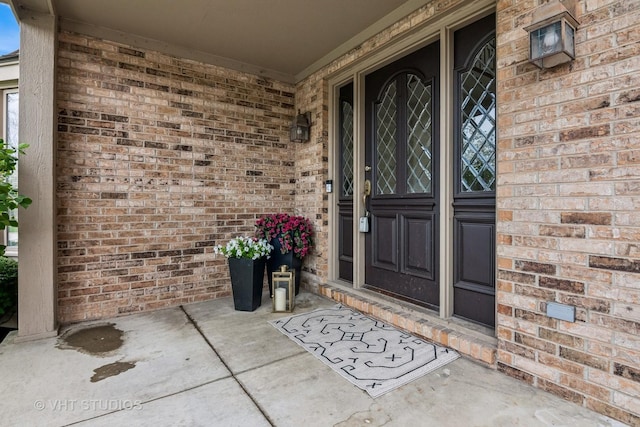 property entrance featuring brick siding