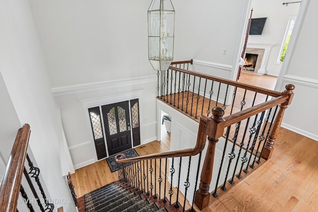 foyer with baseboards, a fireplace, and wood finished floors