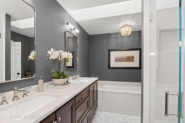 full bath featuring a garden tub, a shower stall, and double vanity