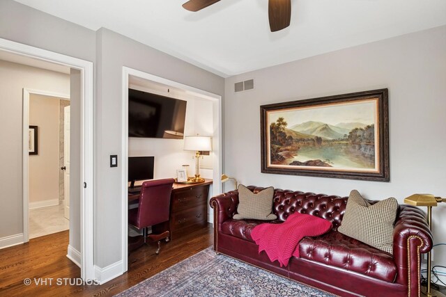 living room with wood finished floors, ceiling fan, an office area, and baseboards