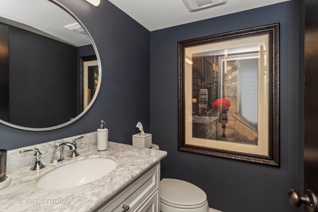 half bath with vanity and toilet