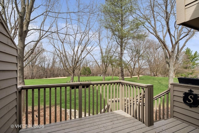 wooden deck with a lawn