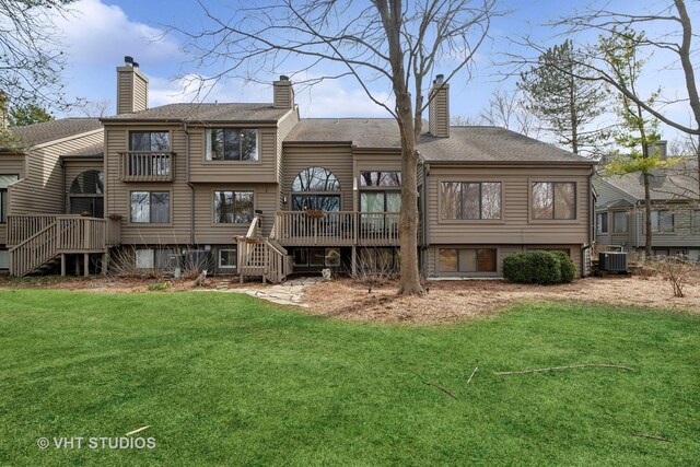 back of property featuring stairs, central AC unit, a deck, and a yard