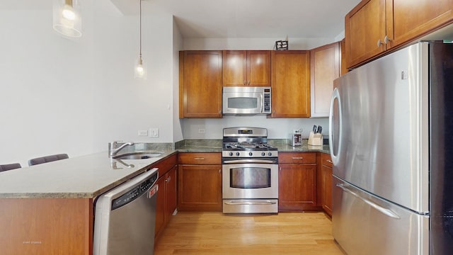 8 W Monroe St Unit 1507, Chicago, IL 60603 - kitchen with stainless steel appliances, a sink, brown cabinets, and light wood-style floors
