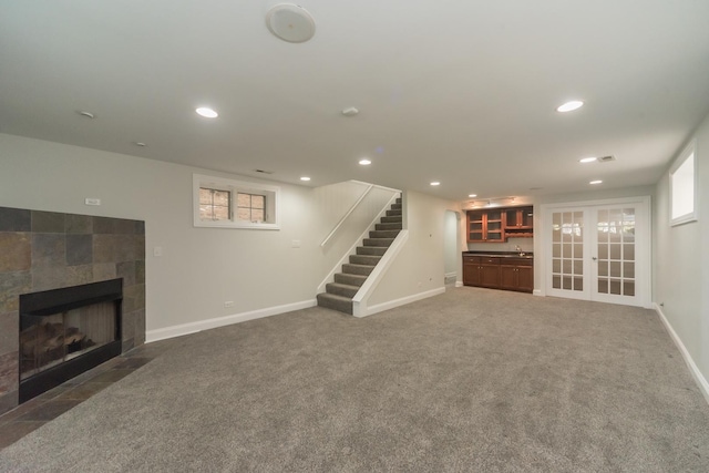 1615 W Superior St, Chicago, IL 60622 - unfurnished living room with stairs, baseboards, a tiled fireplace, recessed lighting, and carpet