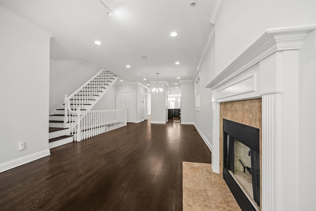 1615 W Superior St, Chicago, IL 60622 - unfurnished living room with crown molding, a tiled fireplace, recessed lighting, wood finished floors, and baseboards