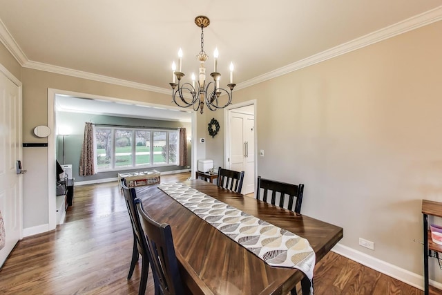dining area with crown molding, baseboards, an inviting chandelier, and wood finished floors
