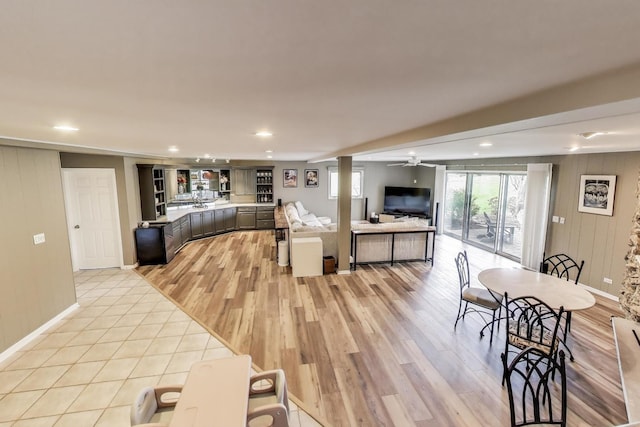 interior space with light wood finished floors, ceiling fan, light countertops, and recessed lighting