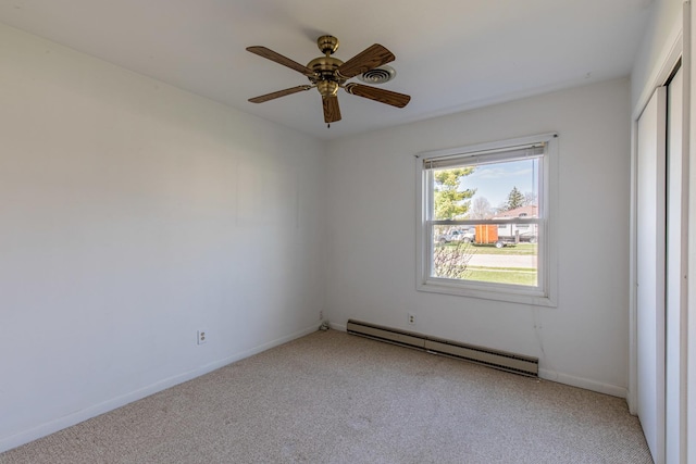 carpeted empty room with baseboards, a ceiling fan, and baseboard heating