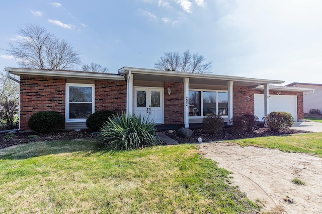 single story home featuring concrete driveway, brick siding, a front lawn, and an attached garage