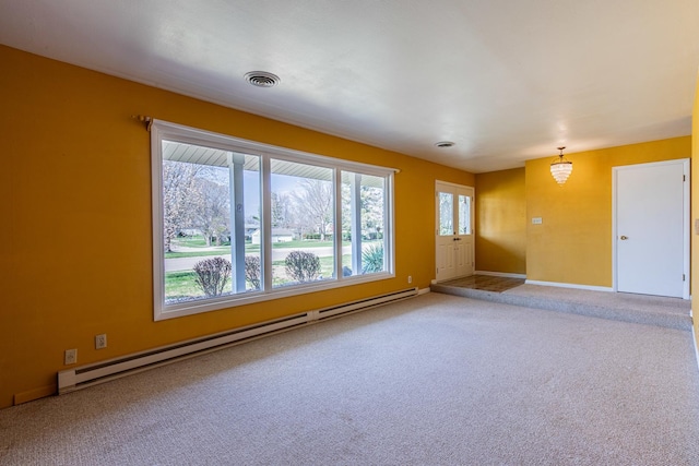 interior space with visible vents, baseboards, carpet flooring, and a baseboard heating unit