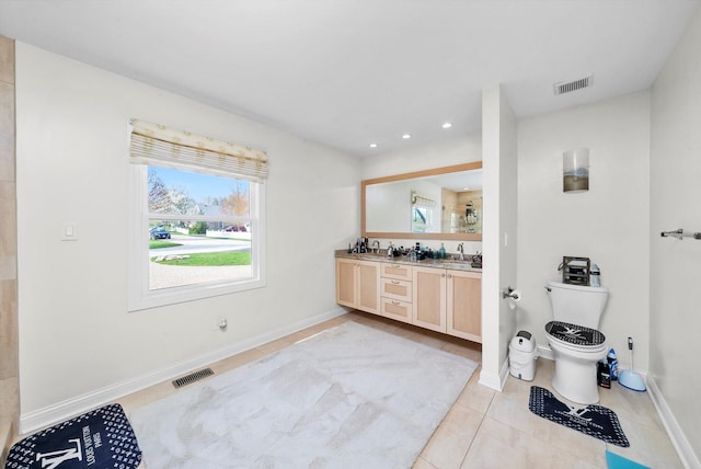 full bathroom featuring toilet, visible vents, and a sink