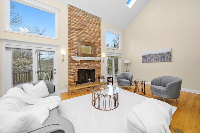 living room featuring a wealth of natural light, wood finished floors, and high vaulted ceiling